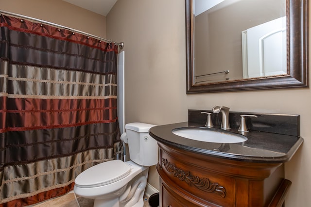 bathroom featuring walk in shower, vanity, and toilet