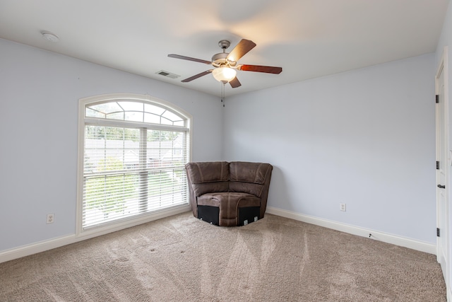 unfurnished room featuring ceiling fan and carpet