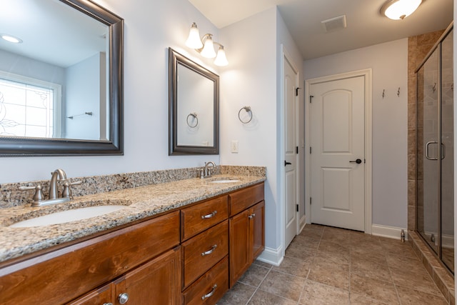 bathroom with walk in shower and vanity