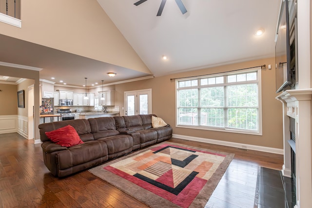 living room featuring ornamental molding, dark hardwood / wood-style flooring, ceiling fan, and high vaulted ceiling