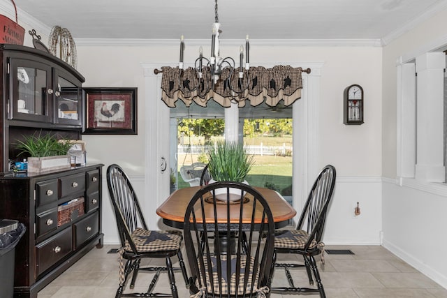 dining space featuring ornamental molding, light tile patterned floors, and a notable chandelier