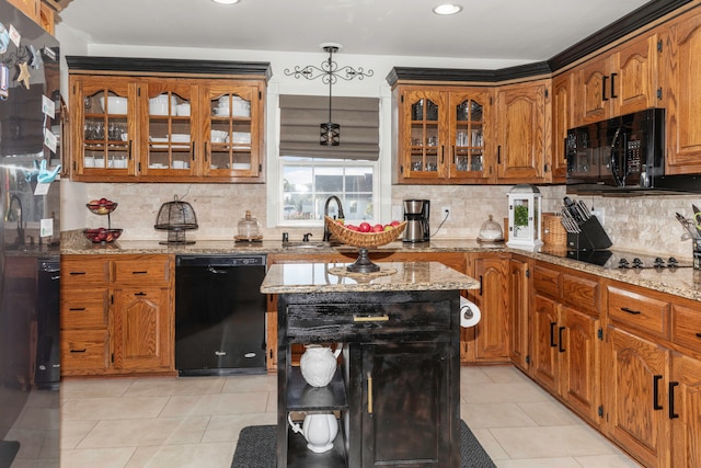 kitchen featuring light stone counters, light tile patterned flooring, backsplash, and black appliances