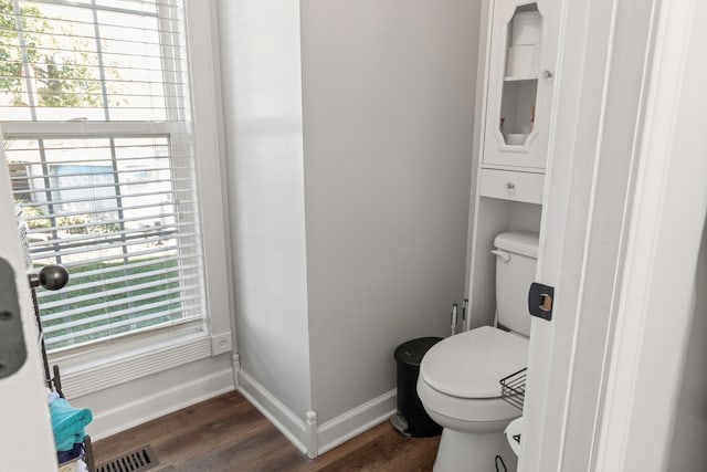 bathroom with wood-type flooring, plenty of natural light, and toilet