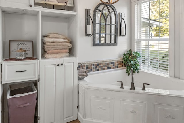 bathroom featuring a tub to relax in and plenty of natural light