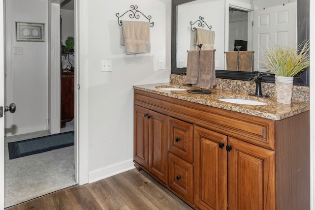 bathroom with hardwood / wood-style flooring and vanity