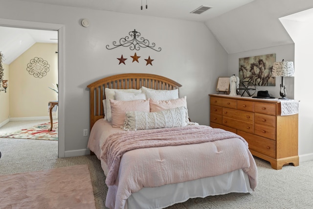 bedroom with carpet floors and lofted ceiling