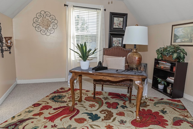 carpeted office space featuring vaulted ceiling