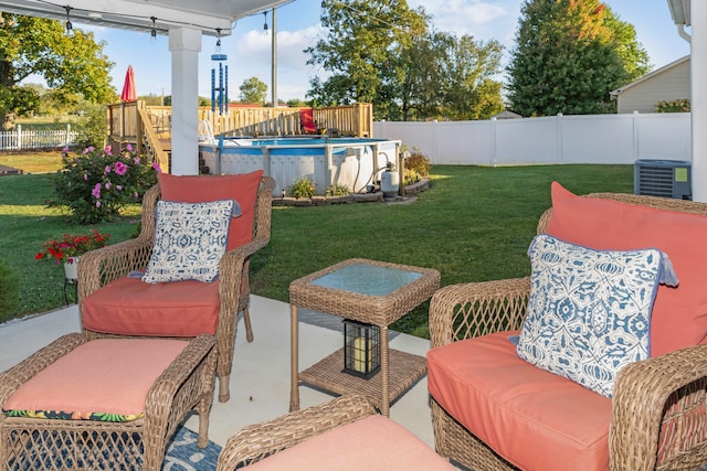 view of patio with a fenced in pool and central air condition unit