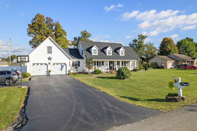 cape cod home featuring covered porch, a front yard, and a garage