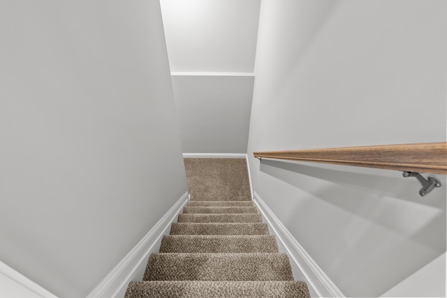 stairway with carpet and baseboards