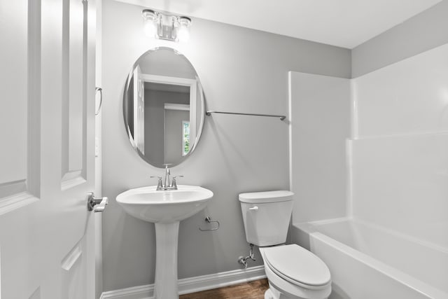 full bathroom with shower / washtub combination, baseboards, toilet, and wood finished floors