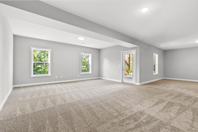 spare room featuring recessed lighting, carpet flooring, and baseboards