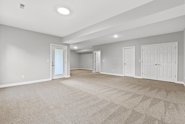 carpeted empty room featuring visible vents and baseboards