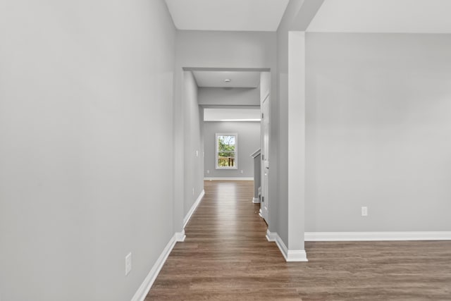 hall with wood finished floors and baseboards