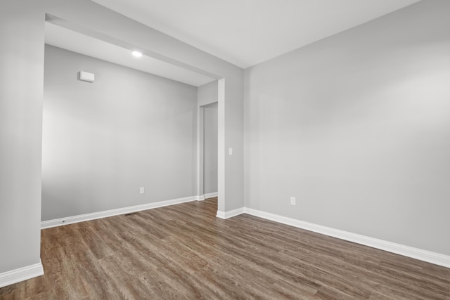 unfurnished room featuring baseboards and wood finished floors