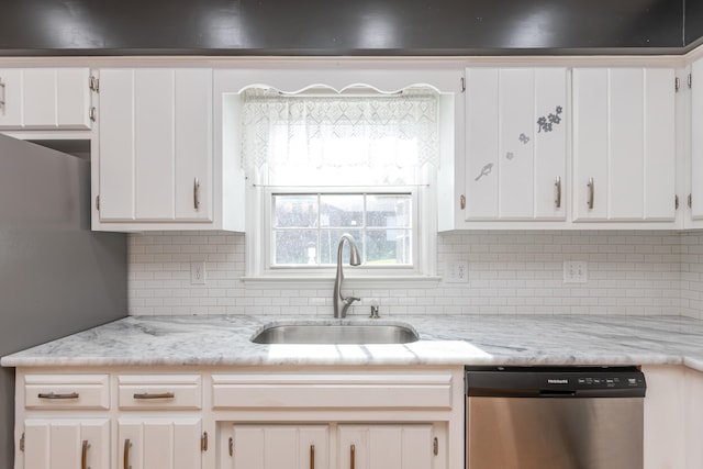 kitchen with white cabinetry, decorative backsplash, dishwasher, and sink