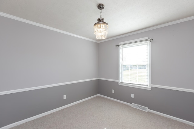 unfurnished room featuring crown molding, a textured ceiling, carpet floors, and a chandelier