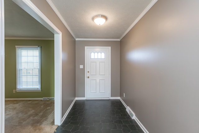 entryway featuring ornamental molding, a textured ceiling, and dark colored carpet