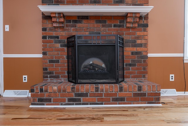 interior details featuring wood-type flooring and a fireplace