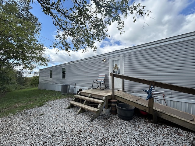 rear view of property featuring a wooden deck