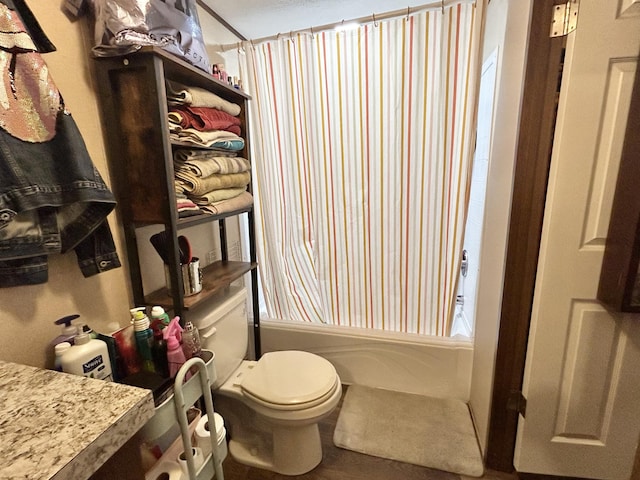 bathroom featuring shower / tub combo with curtain and toilet