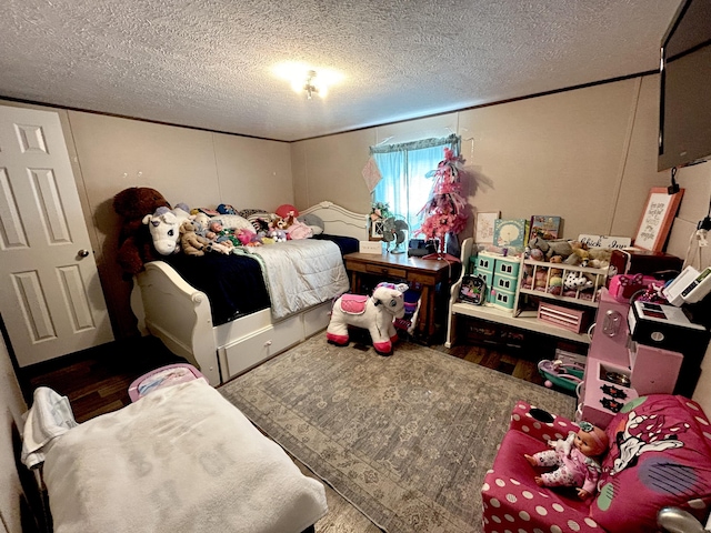 bedroom featuring hardwood / wood-style floors and a textured ceiling