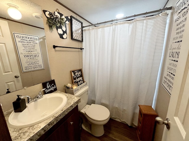 bathroom with vanity, toilet, a textured ceiling, walk in shower, and hardwood / wood-style floors