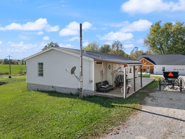 back of house featuring a yard and a patio area