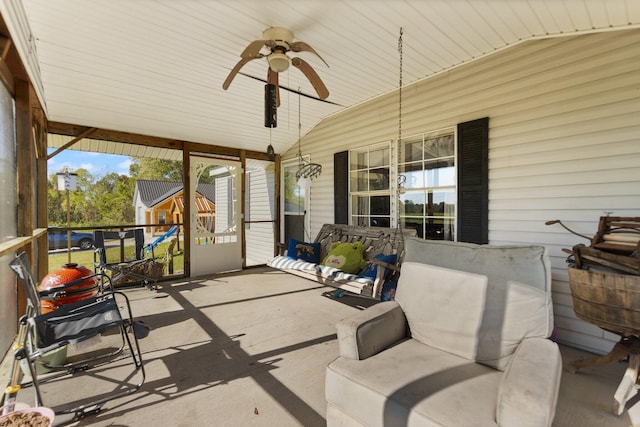 sunroom featuring lofted ceiling and ceiling fan