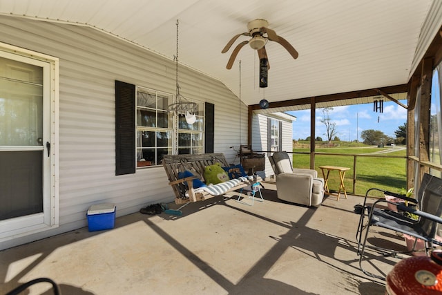 sunroom / solarium with ceiling fan and lofted ceiling