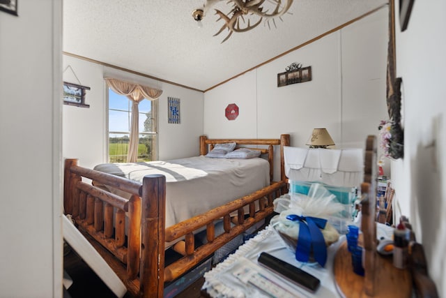 bedroom with a textured ceiling, lofted ceiling, and crown molding