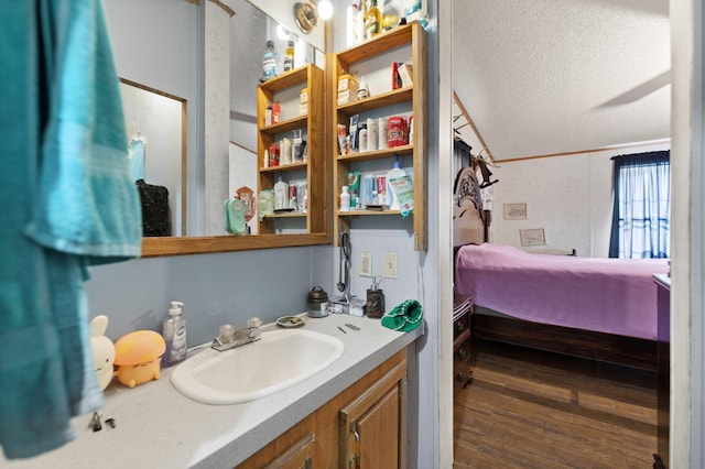 bathroom featuring ornamental molding, hardwood / wood-style flooring, and vanity