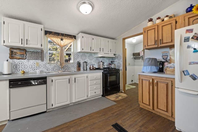 kitchen featuring white appliances, dark hardwood / wood-style floors, and white cabinetry