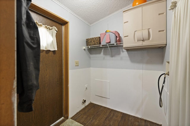 clothes washing area with dark wood-type flooring, ornamental molding, hookup for a washing machine, and a textured ceiling