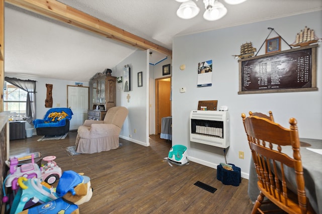 living room featuring dark wood-type flooring, heating unit, and lofted ceiling with beams