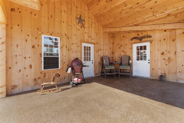 interior space featuring wooden ceiling, high vaulted ceiling, and beam ceiling