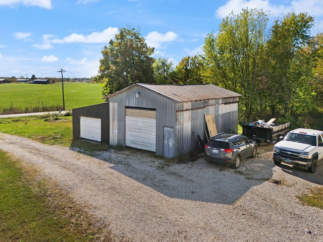 garage featuring a lawn