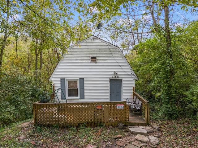 back of property featuring a deck