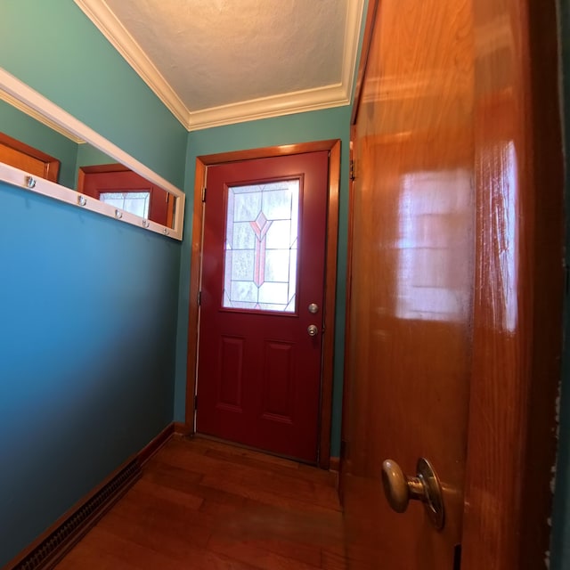 entryway featuring baseboards, a textured ceiling, wood finished floors, and crown molding