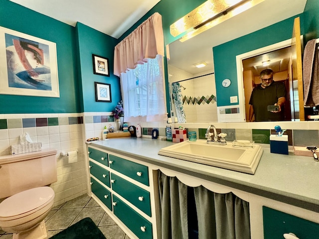 full bathroom featuring tile walls, toilet, wainscoting, vanity, and tile patterned flooring