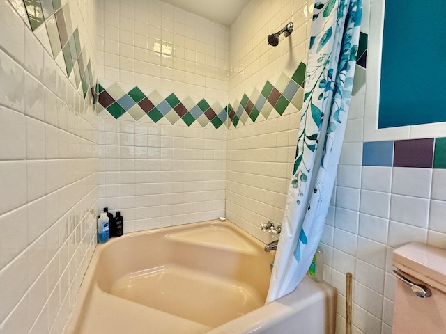 full bathroom with shower / tub combo with curtain and tile walls