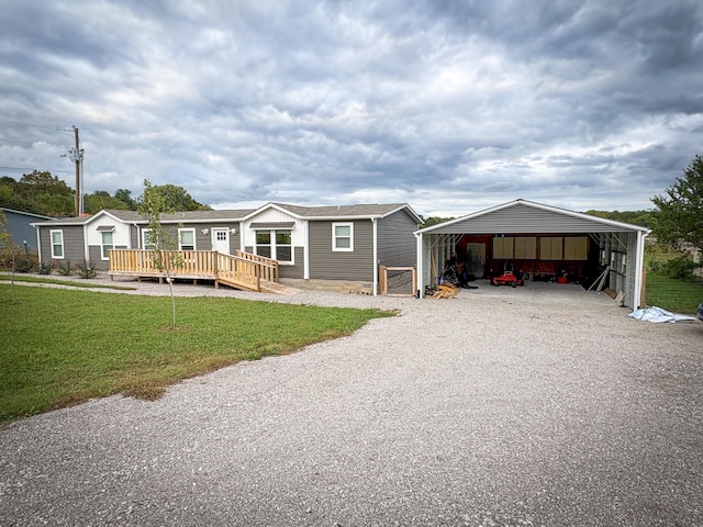 view of front facade featuring a wooden deck, a front lawn, and a carport