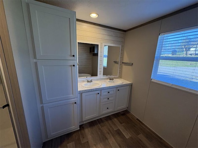 bathroom featuring wood-type flooring, vanity, and ornamental molding