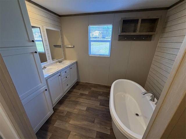 bathroom featuring hardwood / wood-style floors, a bathtub, a healthy amount of sunlight, and vanity