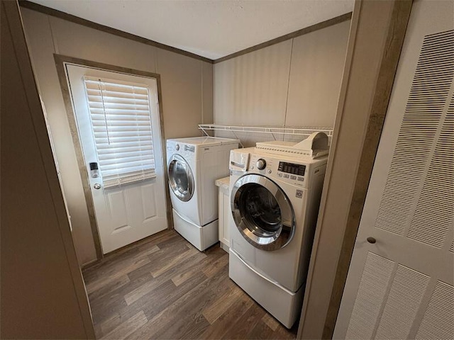 laundry room with separate washer and dryer, crown molding, and dark hardwood / wood-style floors