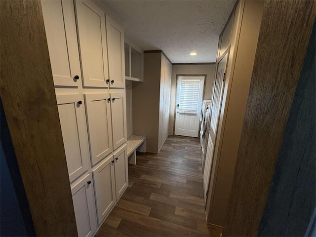 hallway with crown molding, dark hardwood / wood-style flooring, and a textured ceiling