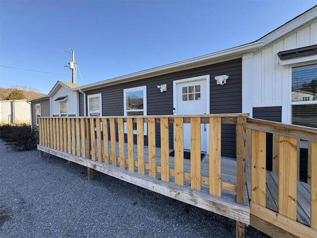 rear view of house featuring a wooden deck