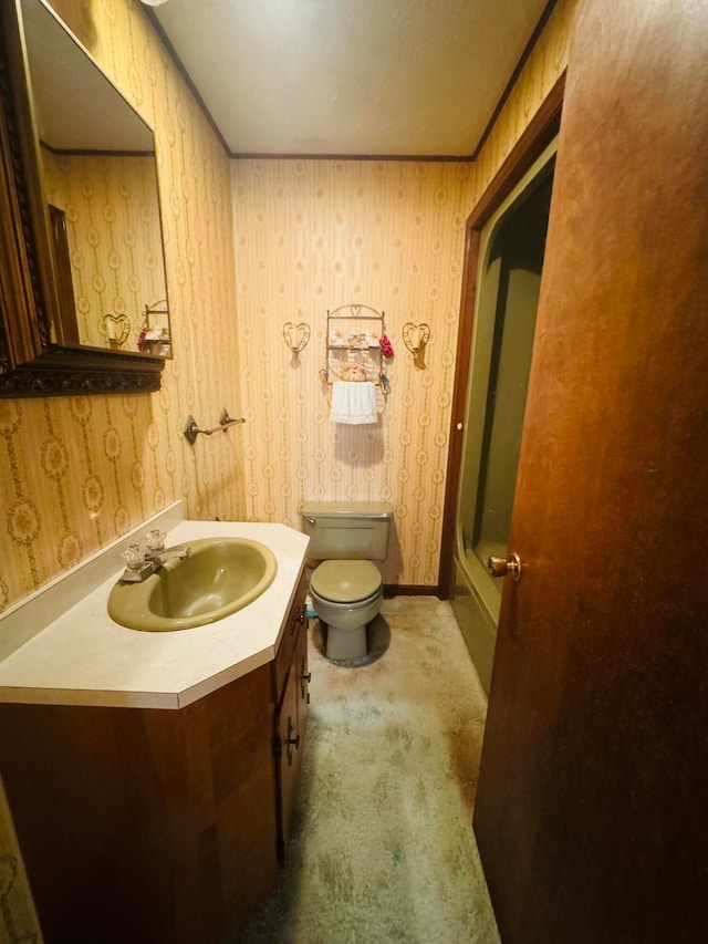 bathroom featuring vanity, a shower with shower door, and toilet