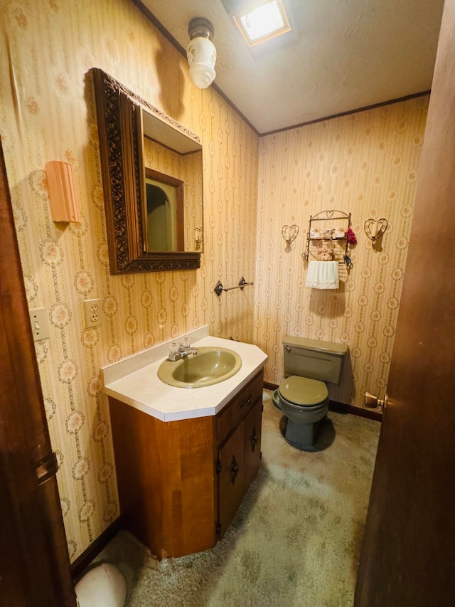 bathroom featuring a textured ceiling, vanity, and toilet