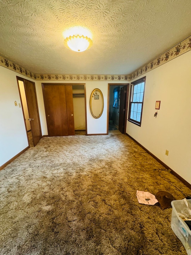 unfurnished bedroom featuring carpet floors and a textured ceiling